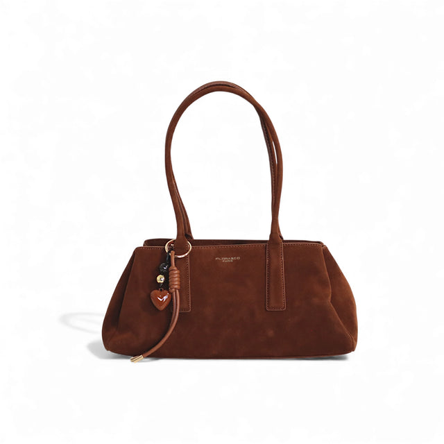Sac à main en cuir marron avec pochettes élégantes et porte-clés décoratif.